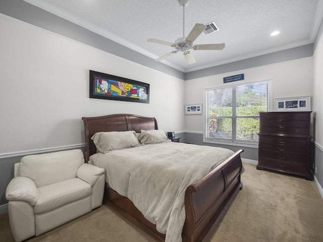 bedroom with light carpet, ceiling fan, ornamental molding, and a textured ceiling