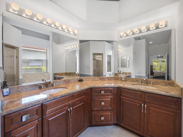 bathroom with tile patterned flooring, walk in shower, and vanity