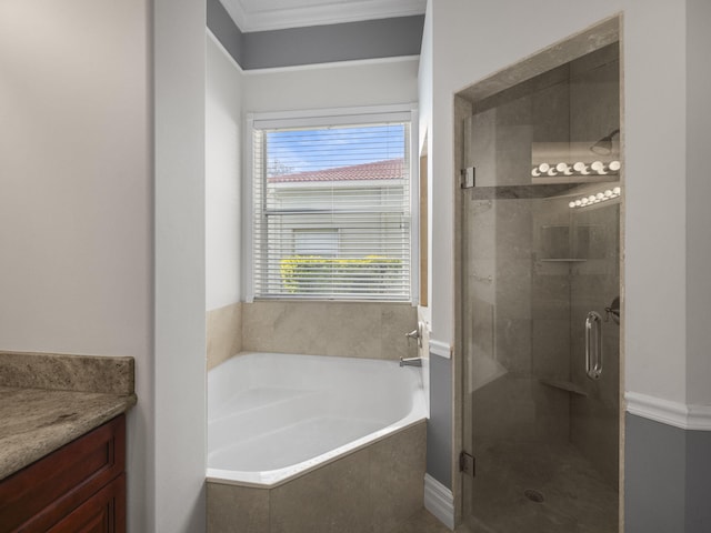 bathroom with ornamental molding, vanity, and shower with separate bathtub