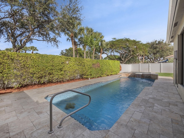 view of swimming pool with pool water feature and a patio