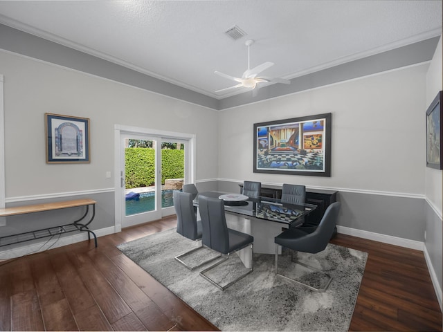 dining space featuring dark hardwood / wood-style flooring, ceiling fan, and ornamental molding