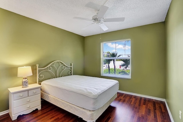 bedroom featuring a textured ceiling, ceiling fan, and dark hardwood / wood-style floors