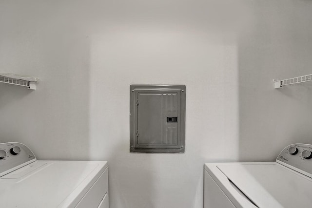 washroom with electric panel and washing machine and clothes dryer