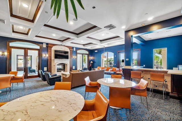 carpeted dining space featuring beam ceiling, french doors, coffered ceiling, and ornamental molding