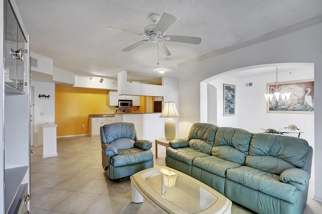 living room with ceiling fan with notable chandelier, a textured ceiling, and light tile patterned flooring