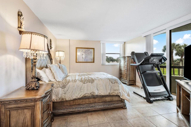 bedroom featuring light tile patterned floors and access to outside