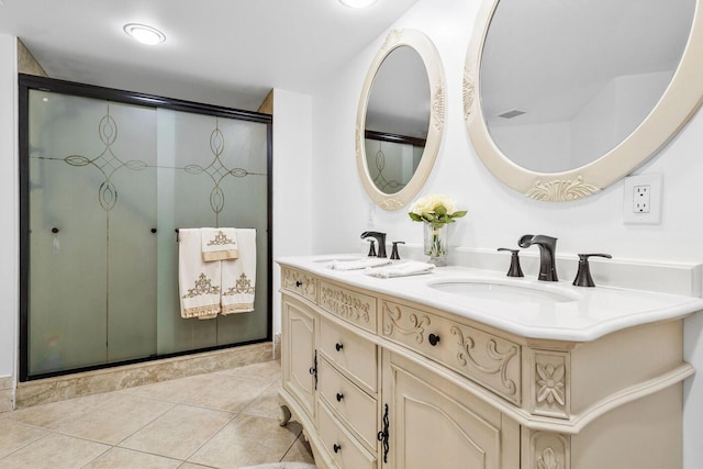 bathroom with an enclosed shower, vanity, and tile patterned floors