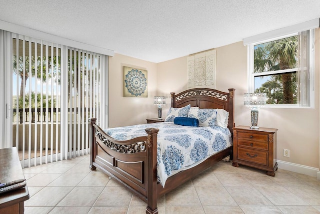 bedroom featuring a textured ceiling, light tile patterned flooring, and multiple windows