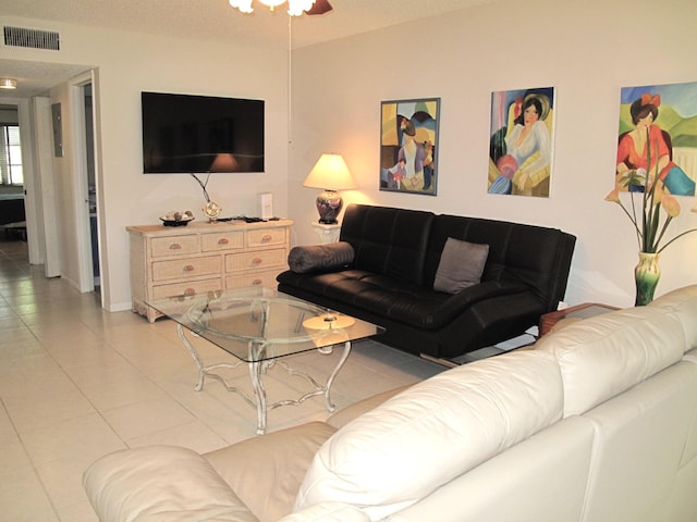 tiled living room with ceiling fan