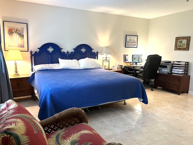 bedroom with a textured ceiling and light tile patterned floors