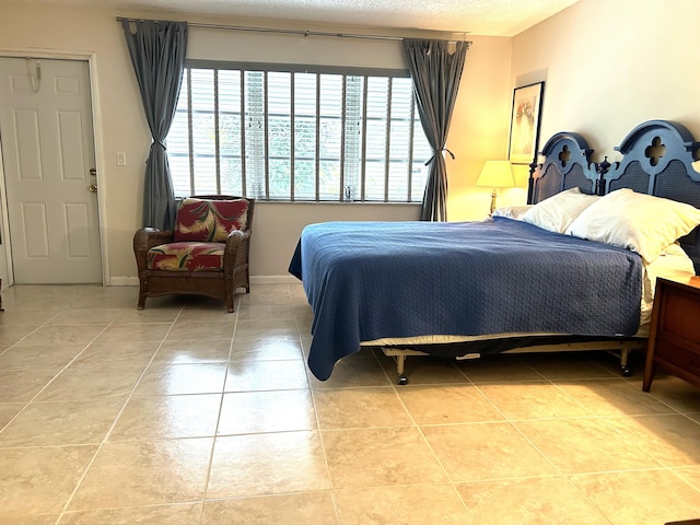 tiled bedroom with a textured ceiling