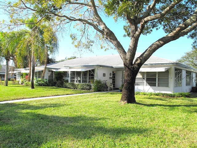 ranch-style home with a front lawn