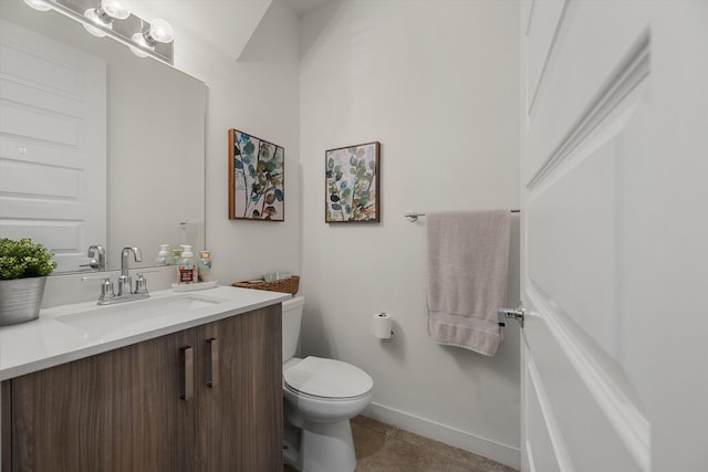 bathroom with tile patterned flooring, vanity, and toilet