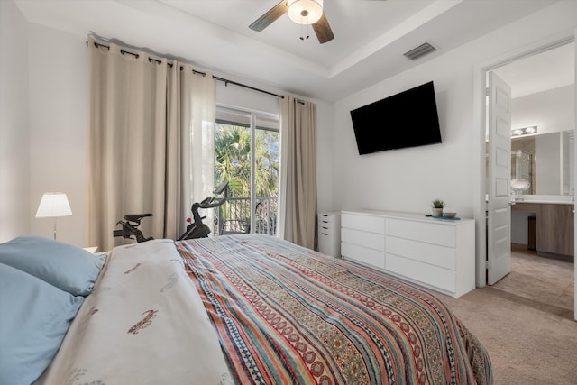 carpeted bedroom featuring a raised ceiling, ceiling fan, access to exterior, and connected bathroom