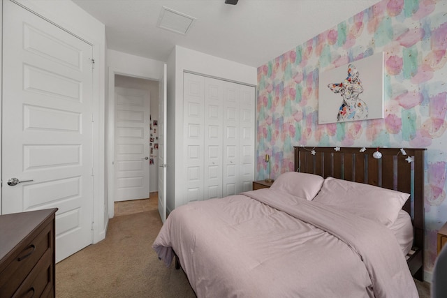 bedroom with a closet and light colored carpet