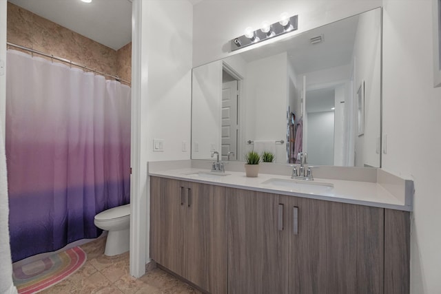 bathroom with toilet, vanity, and curtained shower