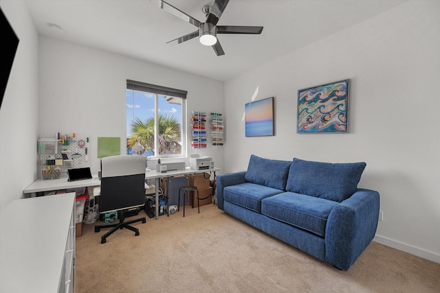 office space featuring light carpet and ceiling fan