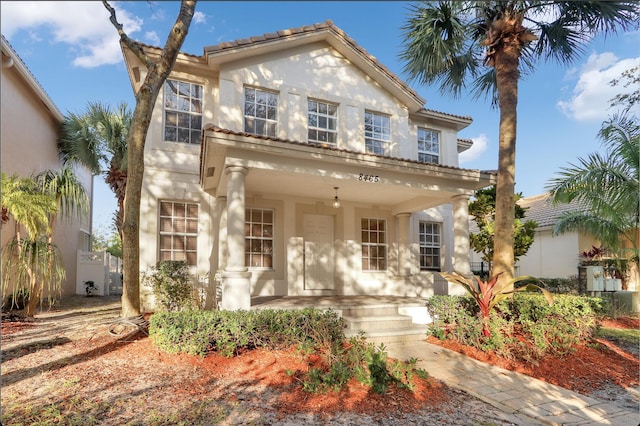 mediterranean / spanish-style house with a porch