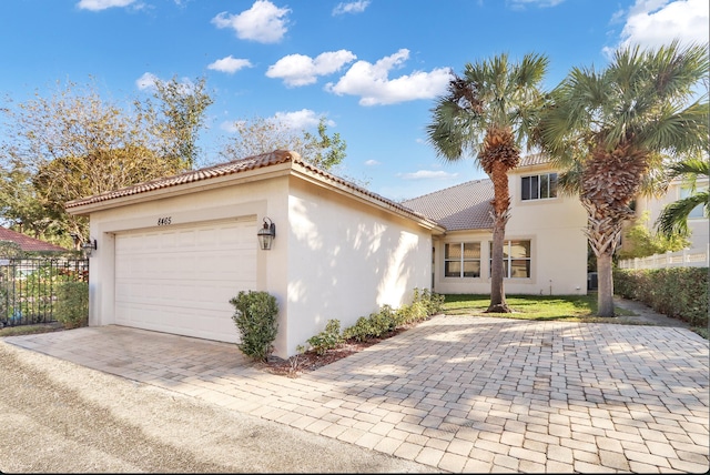 mediterranean / spanish-style home with a garage