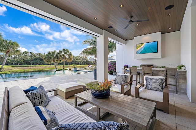 view of patio / terrace with exterior bar, an outdoor hangout area, ceiling fan, and a water view