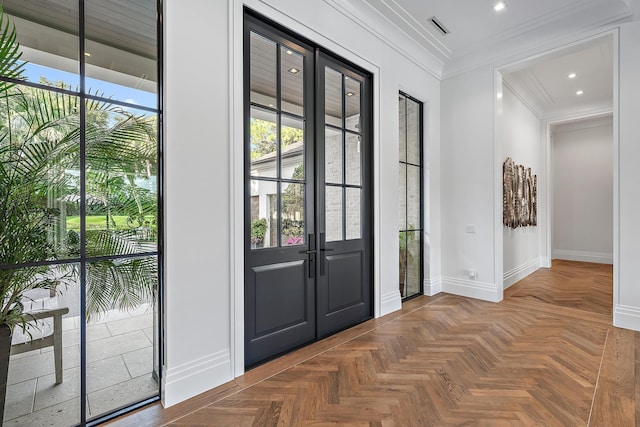 entryway featuring french doors, parquet flooring, ornamental molding, and a wealth of natural light