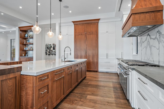 kitchen featuring sink, white cabinetry, double oven range, dark hardwood / wood-style flooring, and decorative light fixtures