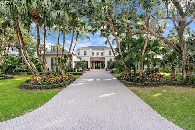 mediterranean / spanish-style house featuring a front lawn