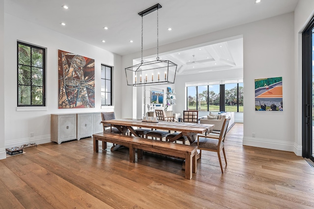 dining space with an inviting chandelier and light wood-type flooring