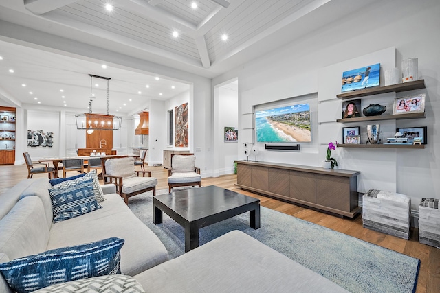 living room featuring beam ceiling and light wood-type flooring