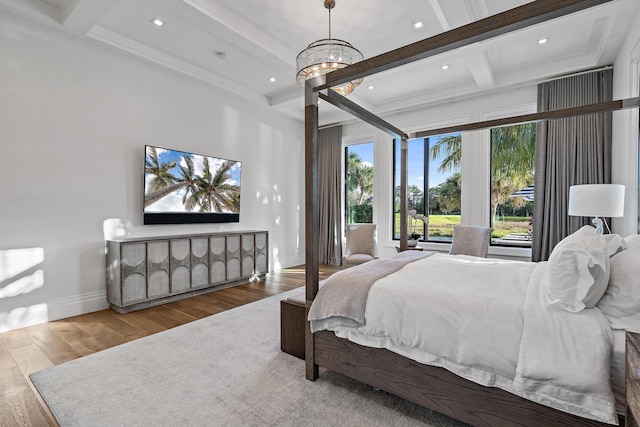 bedroom featuring beam ceiling, a notable chandelier, hardwood / wood-style flooring, and coffered ceiling