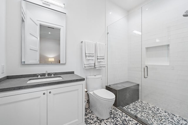 bathroom featuring an enclosed shower, vanity, and toilet