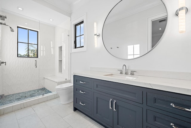 bathroom featuring a healthy amount of sunlight, vanity, toilet, and an enclosed shower