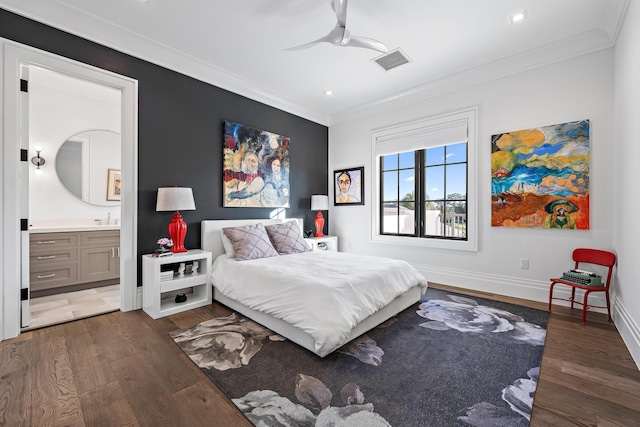 bedroom featuring sink, crown molding, dark wood-type flooring, and ensuite bath