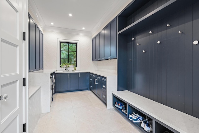 mudroom with crown molding and light tile patterned flooring