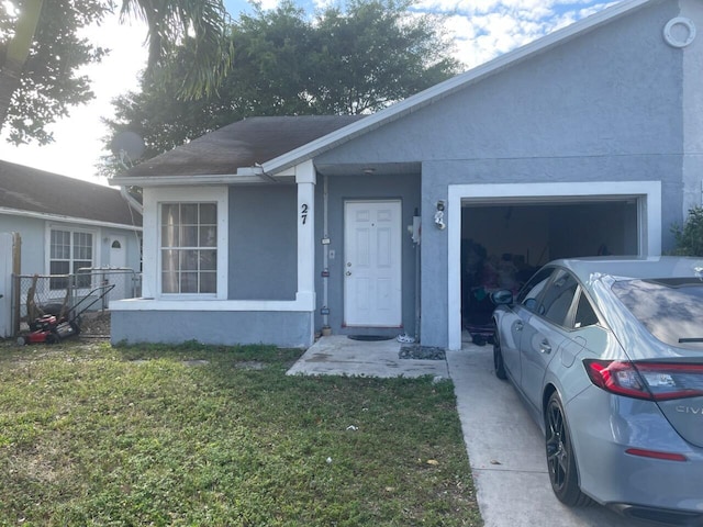 view of front of house with a front yard and a garage