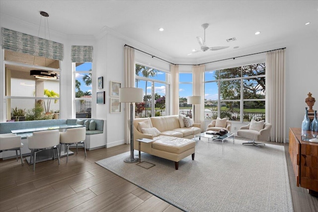 living room featuring ornamental molding and ceiling fan