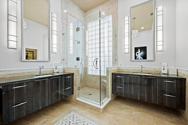 bathroom featuring tile patterned flooring, vanity, and walk in shower