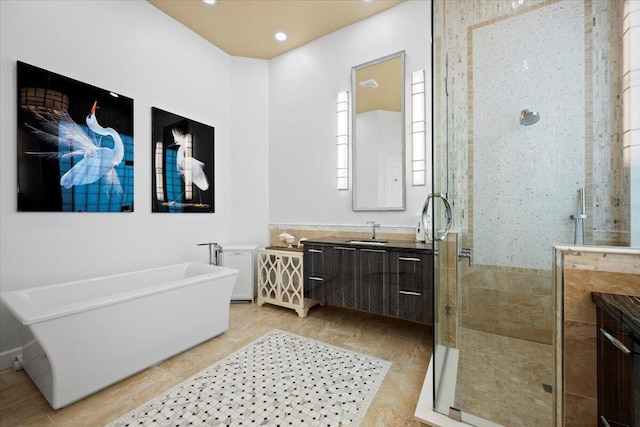 bathroom featuring vanity and plus walk in shower