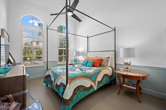 bedroom with ceiling fan and multiple windows