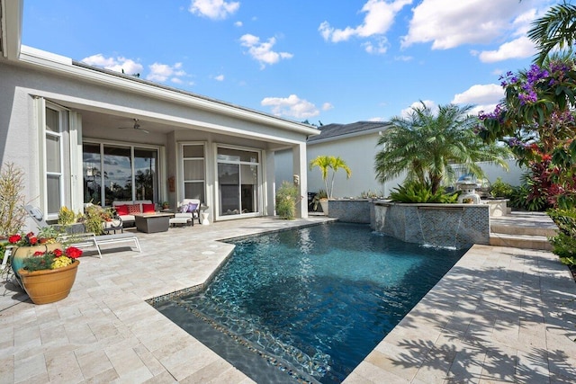 view of pool featuring a patio, outdoor lounge area, ceiling fan, and pool water feature