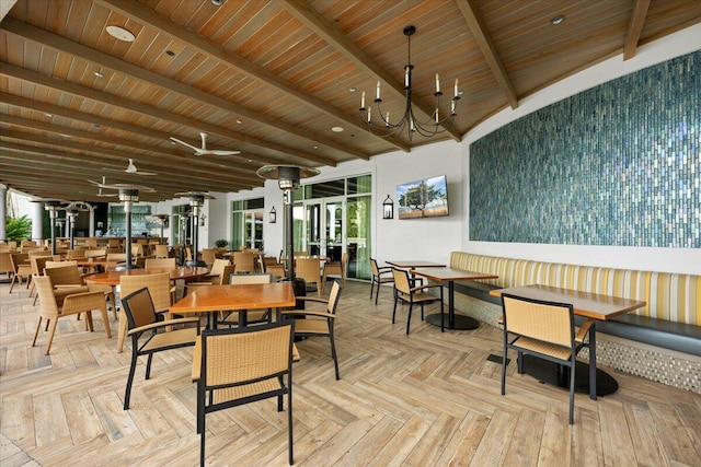 dining area with beamed ceiling, wood ceiling, light parquet flooring, and a chandelier