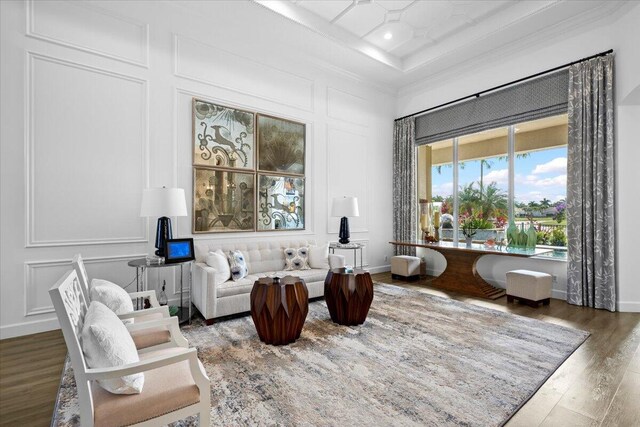 sitting room featuring ornamental molding and hardwood / wood-style floors