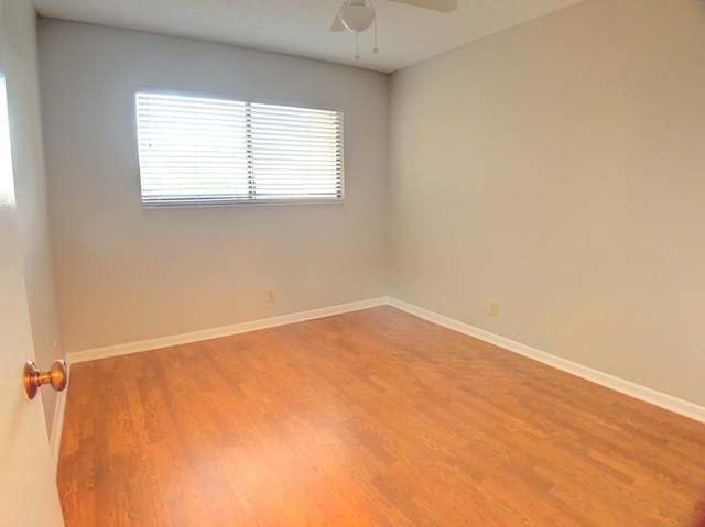 spare room featuring ceiling fan and hardwood / wood-style flooring