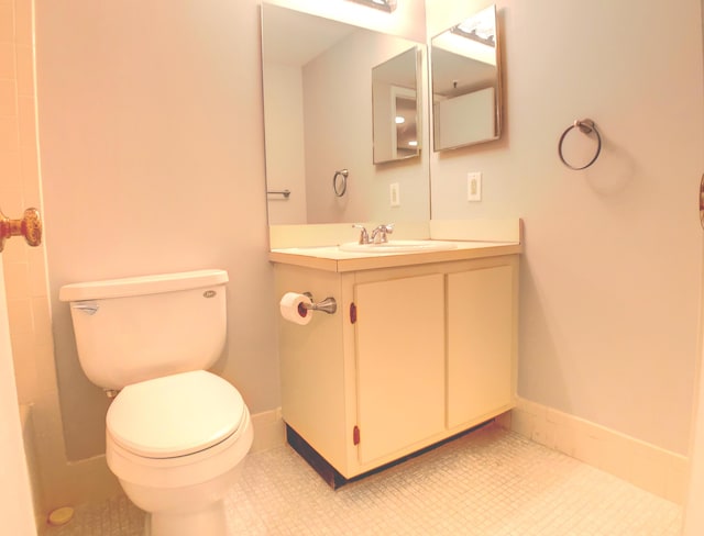 bathroom featuring toilet, tile patterned flooring, and vanity