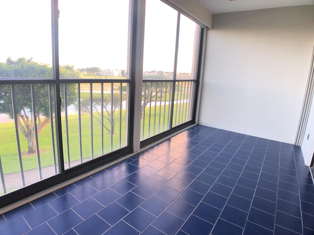 unfurnished sunroom with a water view