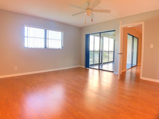 empty room with ceiling fan and hardwood / wood-style flooring