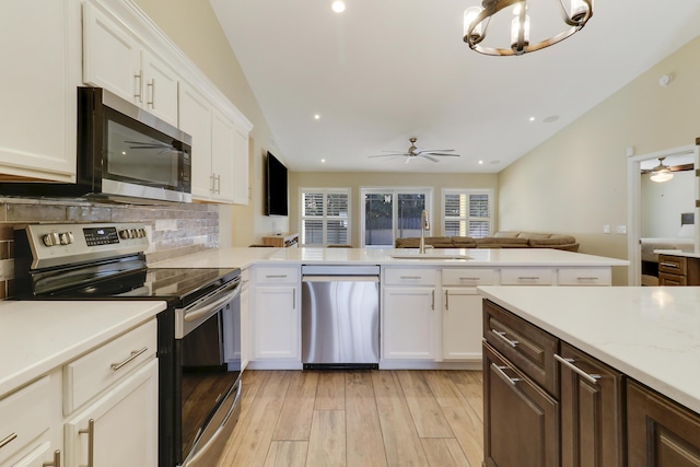 kitchen featuring white cabinets, appliances with stainless steel finishes, sink, and light hardwood / wood-style flooring