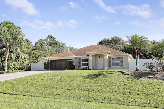 mediterranean / spanish home featuring a front yard and a garage