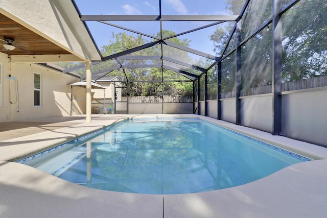 view of swimming pool with a patio and glass enclosure