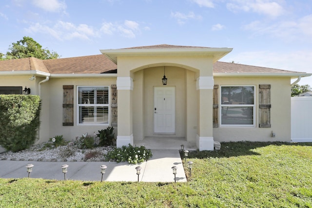 view of exterior entry featuring a yard